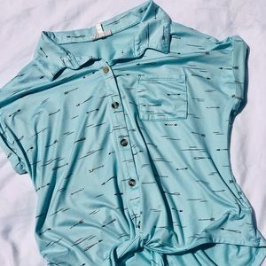 A blue shirt with gold arrows, size XL, from the brand “self esteem”